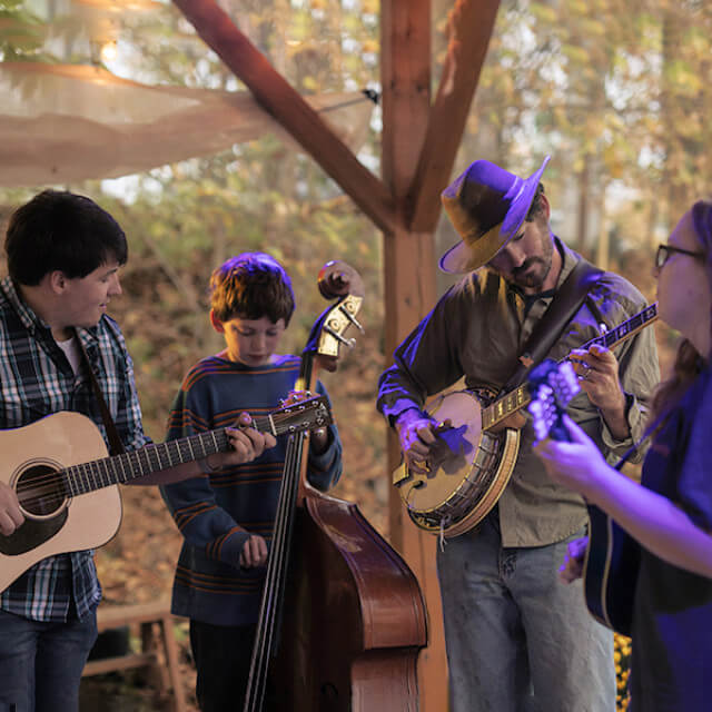 A group plays stringed instruments in West Virginia