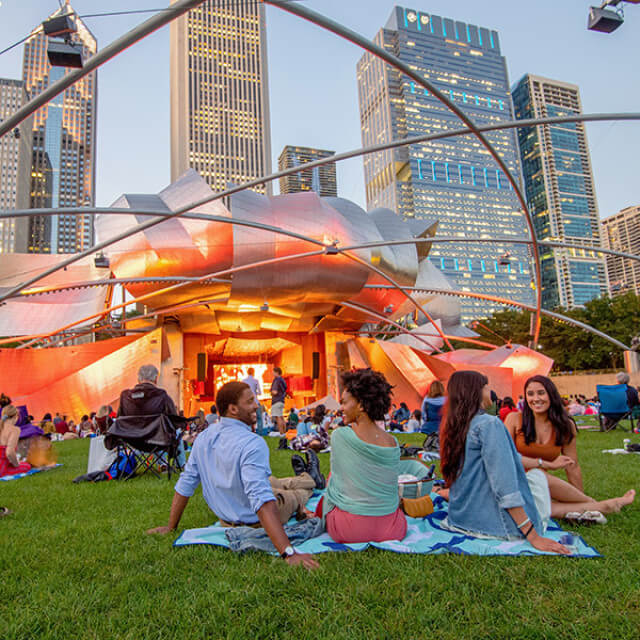 Enjoying a concert on the lawn of Jay Pritzker Pavilion at Millennium Park in Chicago, Illinois