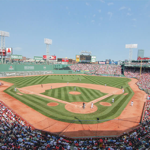A crowd enjoys a baseball game at Fenway Park in Boston, Massachusetts