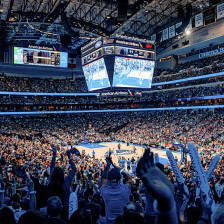 Fans watch a basketball game at the American Airlines Center in Dallas, Texas