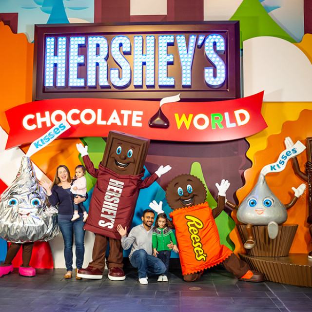 Posing with costumed characters at Hershey's Chocolate World in Hershey, Pennsylvania