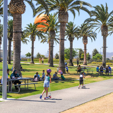 Children play on the tree-lined paths at Great Park in Irvine, California