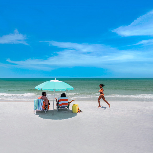 A family enjoys a sunny beach day at Fort De Soto Park in St. Pete-Clearwater, Florida