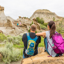 A family explores unique rock formations in Montana's Makoshika State Park