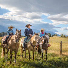 Horseback riding amid mountain peaks in Ronan, Montana