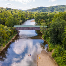 Tubing beneath a covered bridge in Cambridge, Vermont
